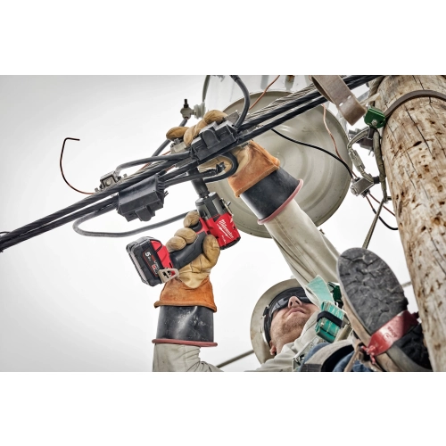 Monter w rękawicach dokręca Milwaukee M18 FMTIW2F12 śruby na słupie energetycznym