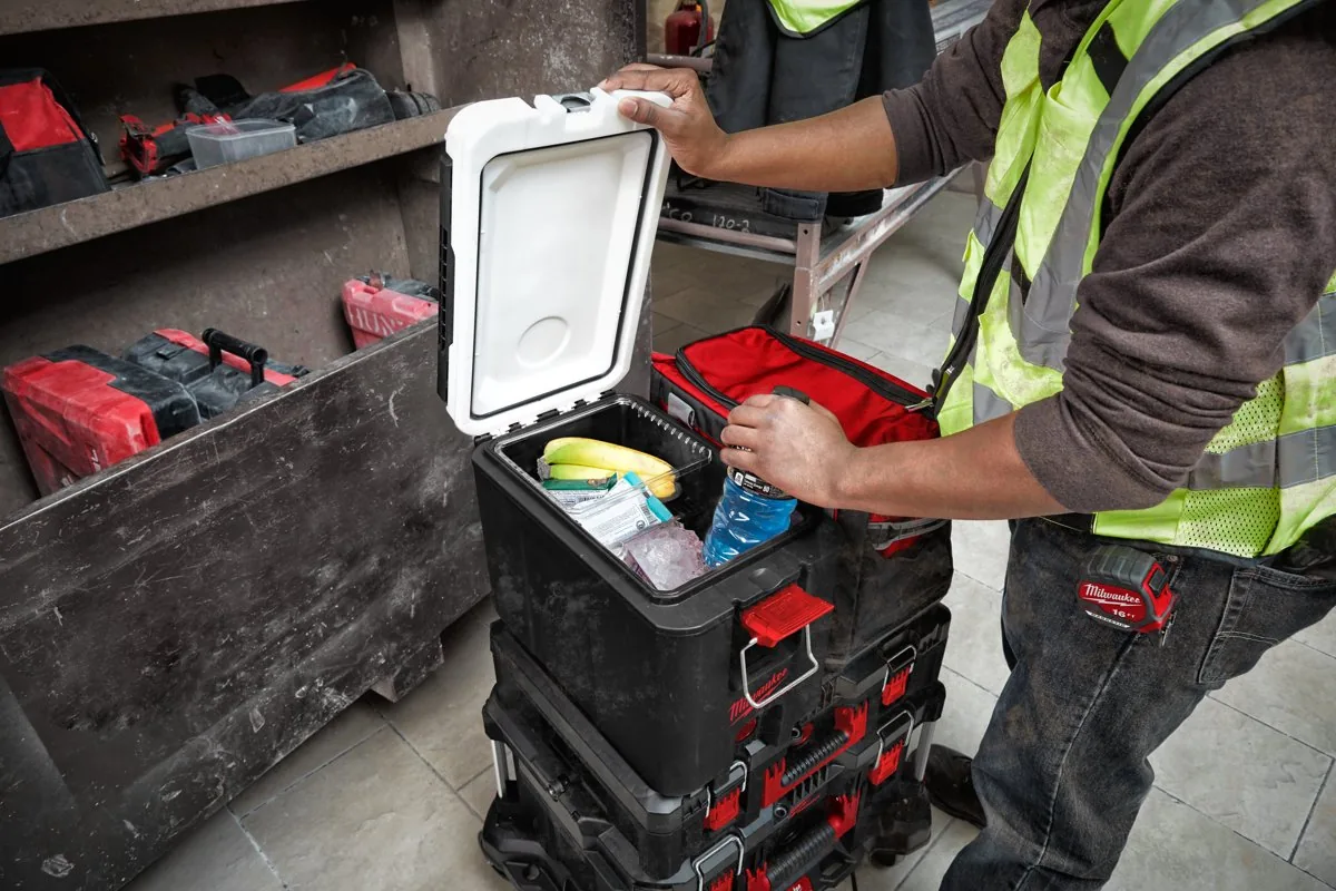 Pracownik wyjmuje napój ze skrzyni termoizolacyjnej PACKOUT